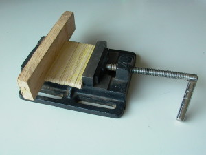 Glued Popsicle stick pressed in a drill vise.