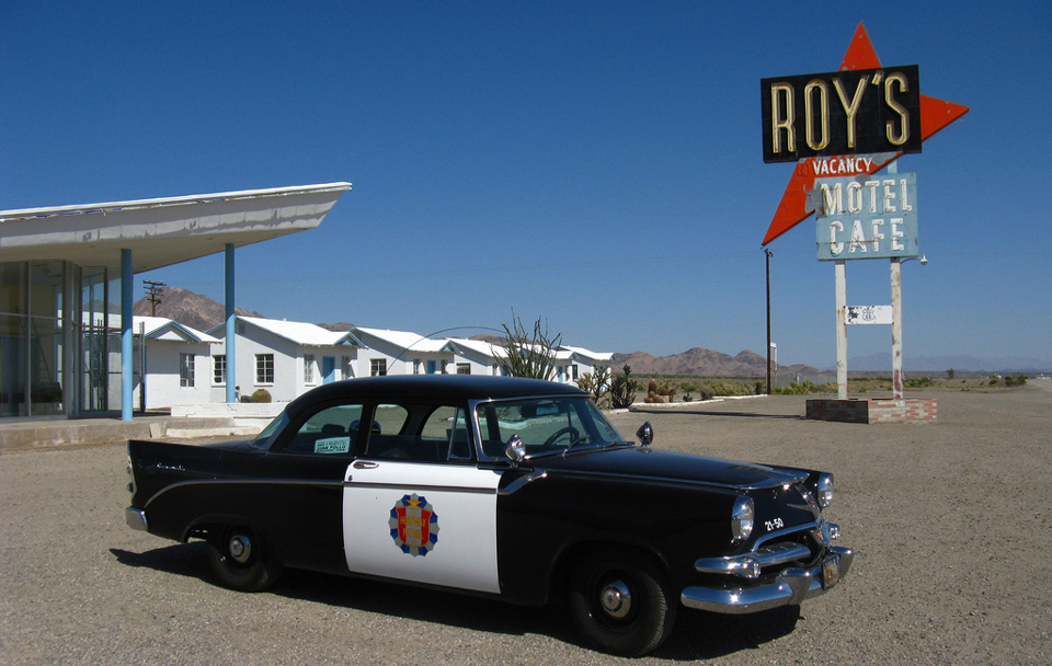 Cover Photo: Police Car and Roy's Sign
